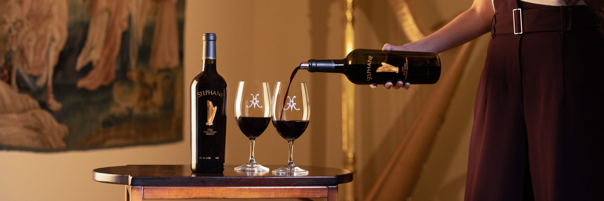 A host pouring a glass of Stephanie Cabernet Sauvignon at the tasting salon.