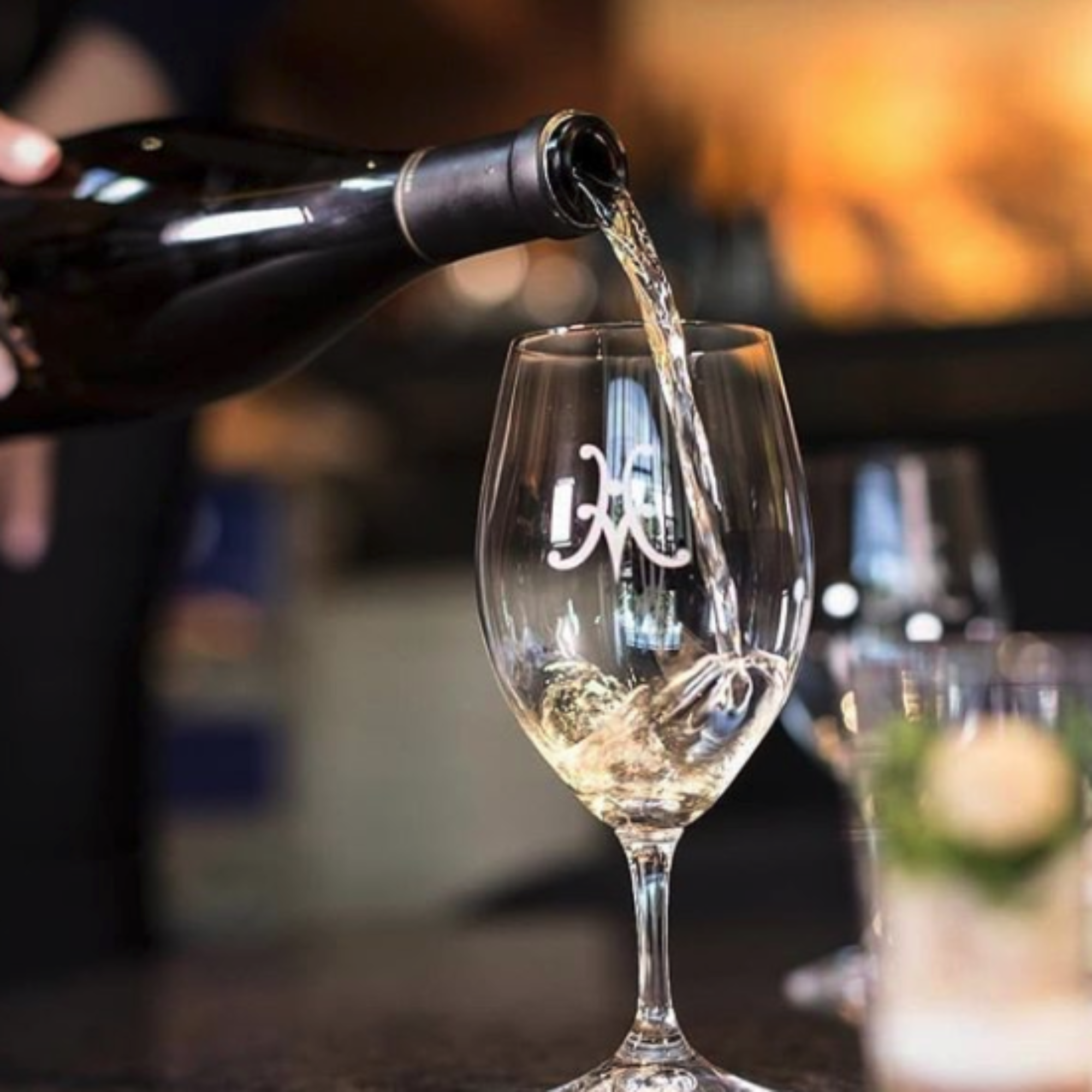 A host pouring a glass at the Tasting Salon.